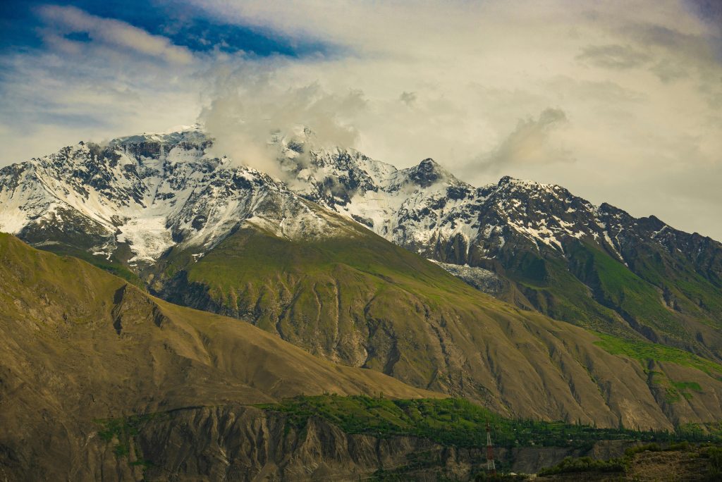 Majestic mountain landscape in Kaghan Valley, Pakistan, showcasing snow-capped peaks and lush greenery.